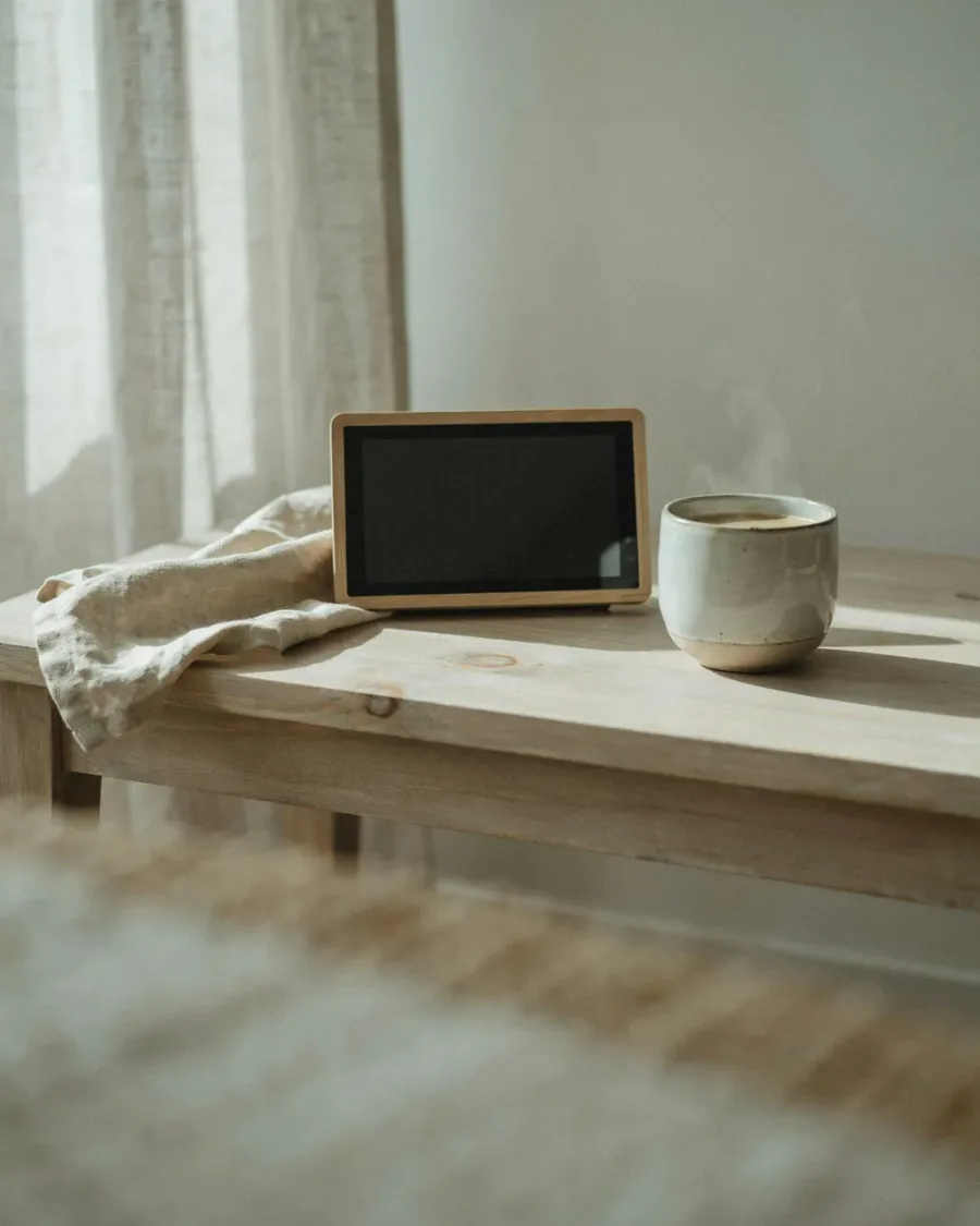 The 7-inch display resting on a table indoors, showing the live Home screen.